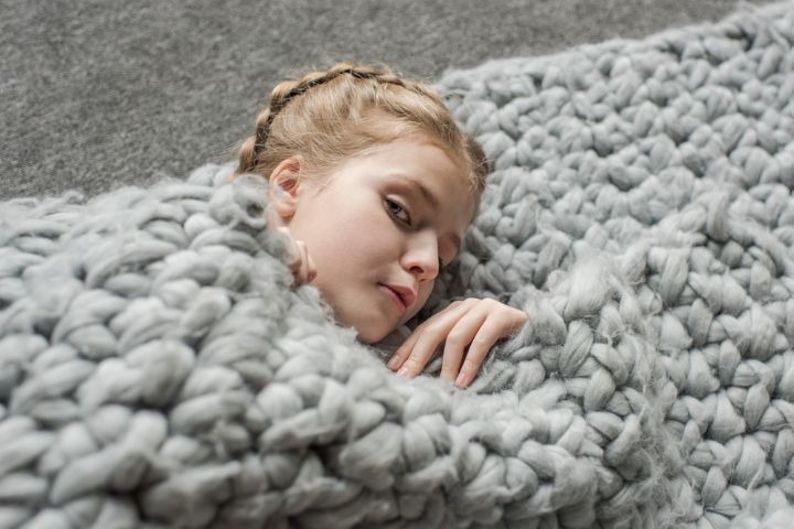 Children sleeping beneath a weighted blanket GETTY Image