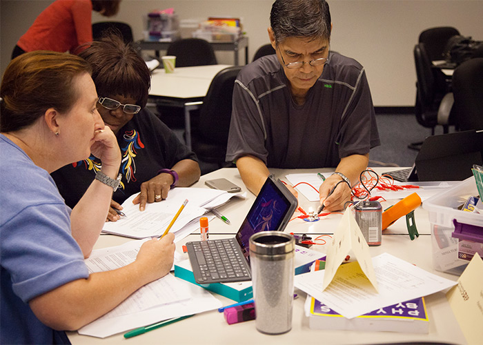 STEP program participants investigate electrical circuits, using both a traditional multimeter and an iPad simulation app.