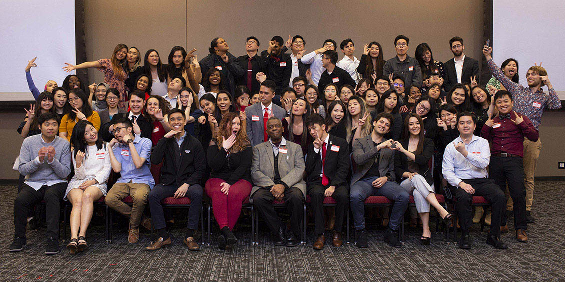 students, alumni and faculty member in group photo