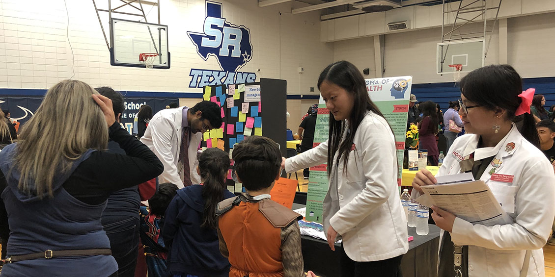 students discuss mental health wellness at event